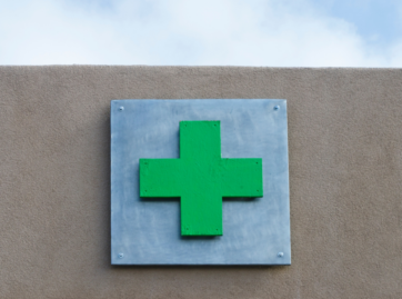 Green plus sign associated with medical marijuana dispensaries, cannabis doctors, and medical cards.